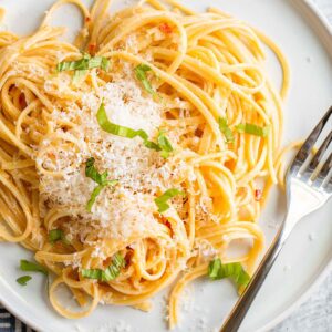 Creamy calabrian pasta topped with fresh parmesan and basil.