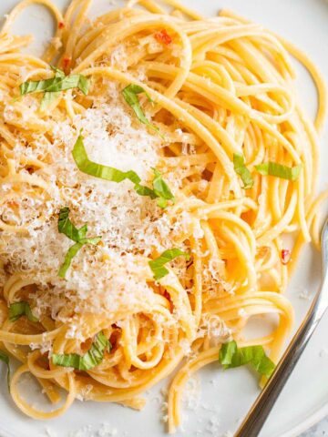 Creamy calabrian pasta topped with fresh parmesan and basil.