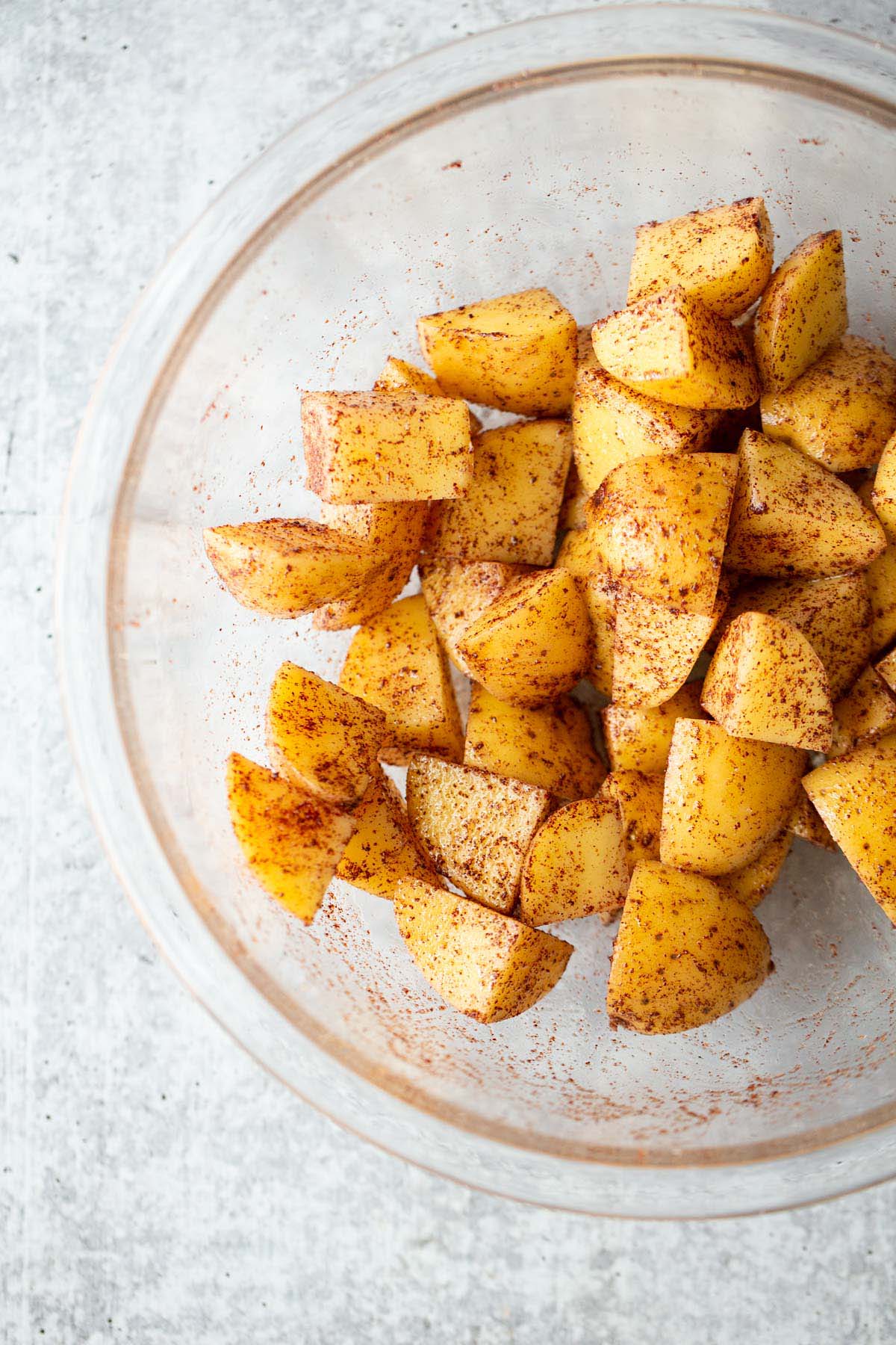 Sumac potatoes in a glass bowl.