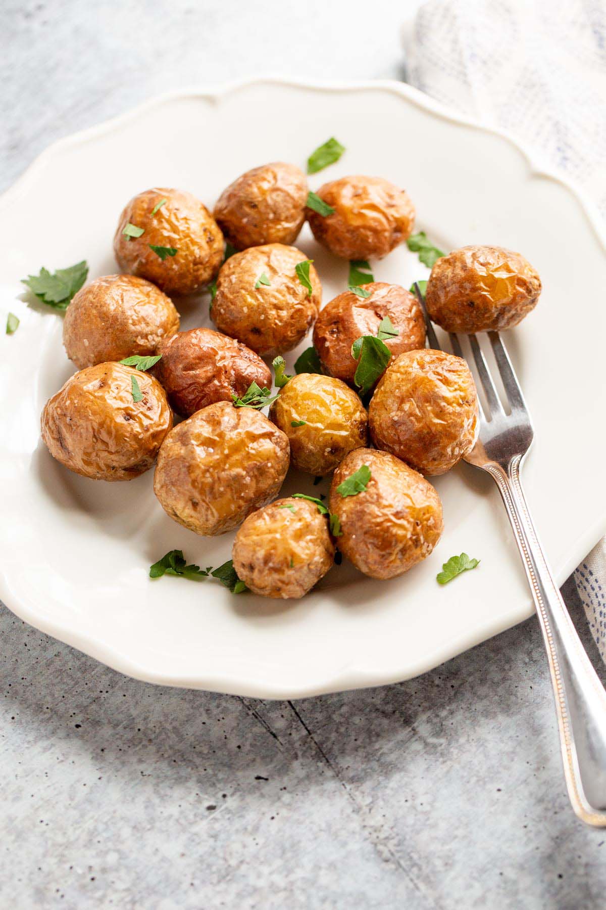 Air fried baby potatoes on a white plate