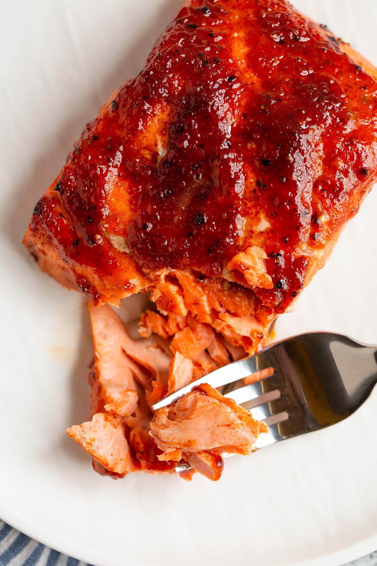 Air fryer bbq salmon flaked with a fork.