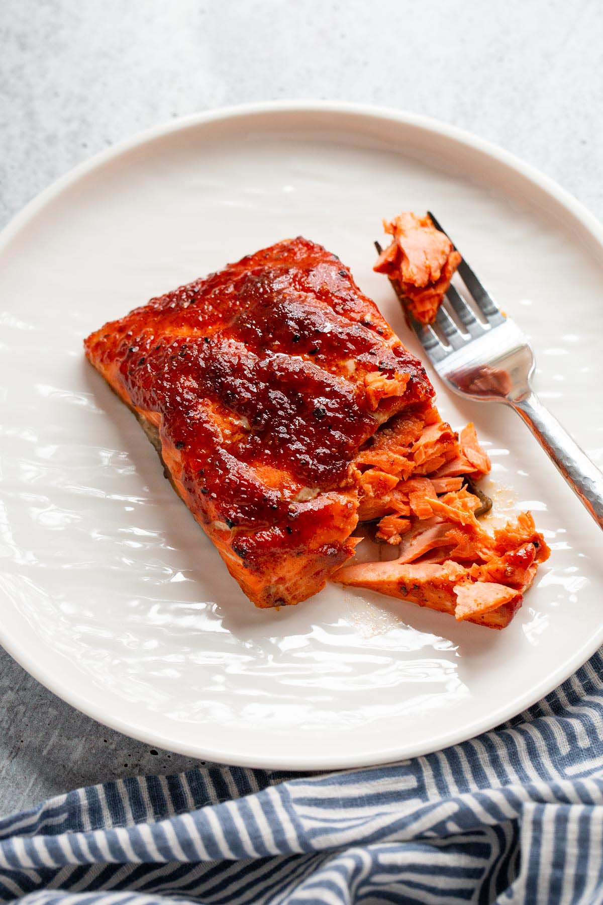 Air fryer bbq salmon flaked with a fork.