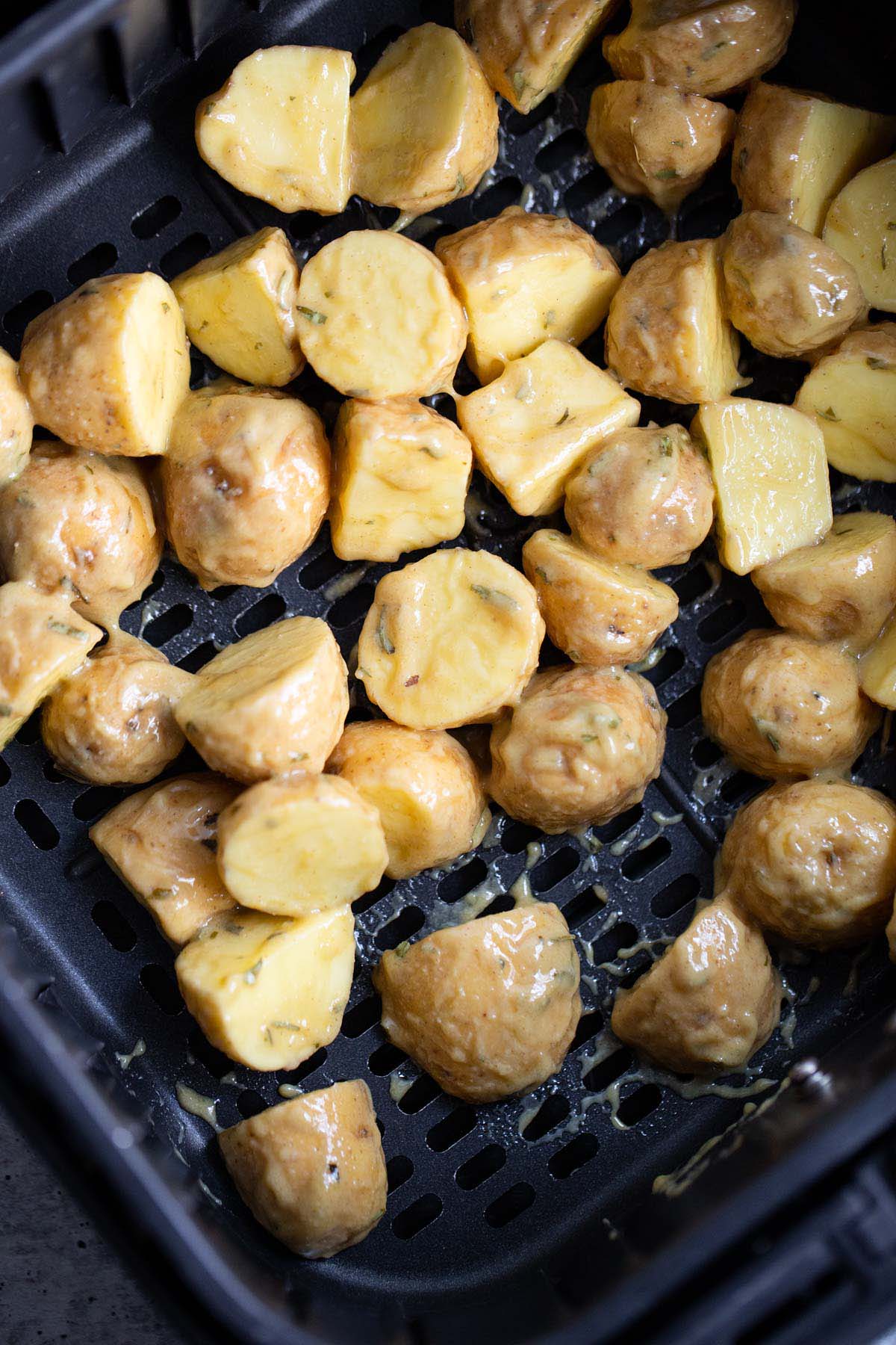 Potatoes in the air fryer basket.