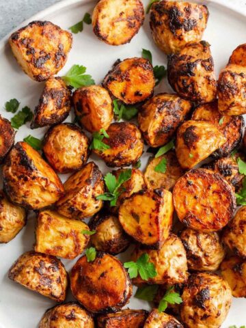 Air fried honey dijon potatoes on a plate.