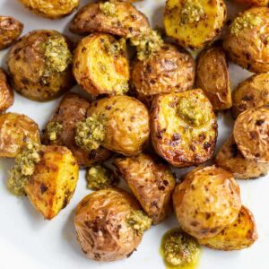 Air fryer pesto potatoes on a white plate.