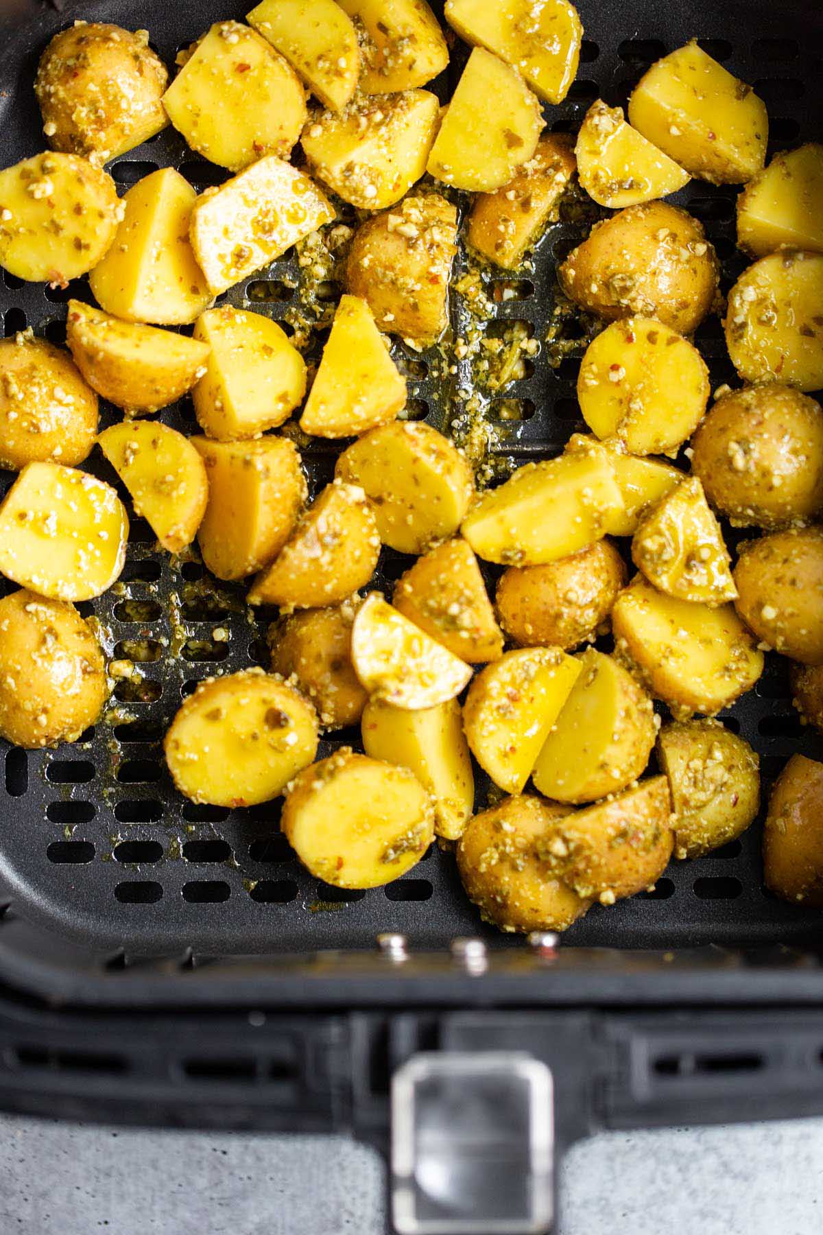 Uncooked potatoes in air fryer.