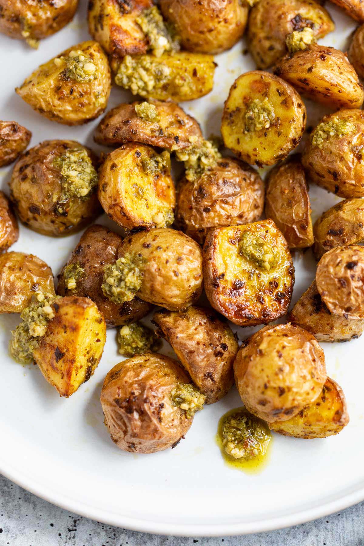 Air fryer pesto potatoes on a white plate.