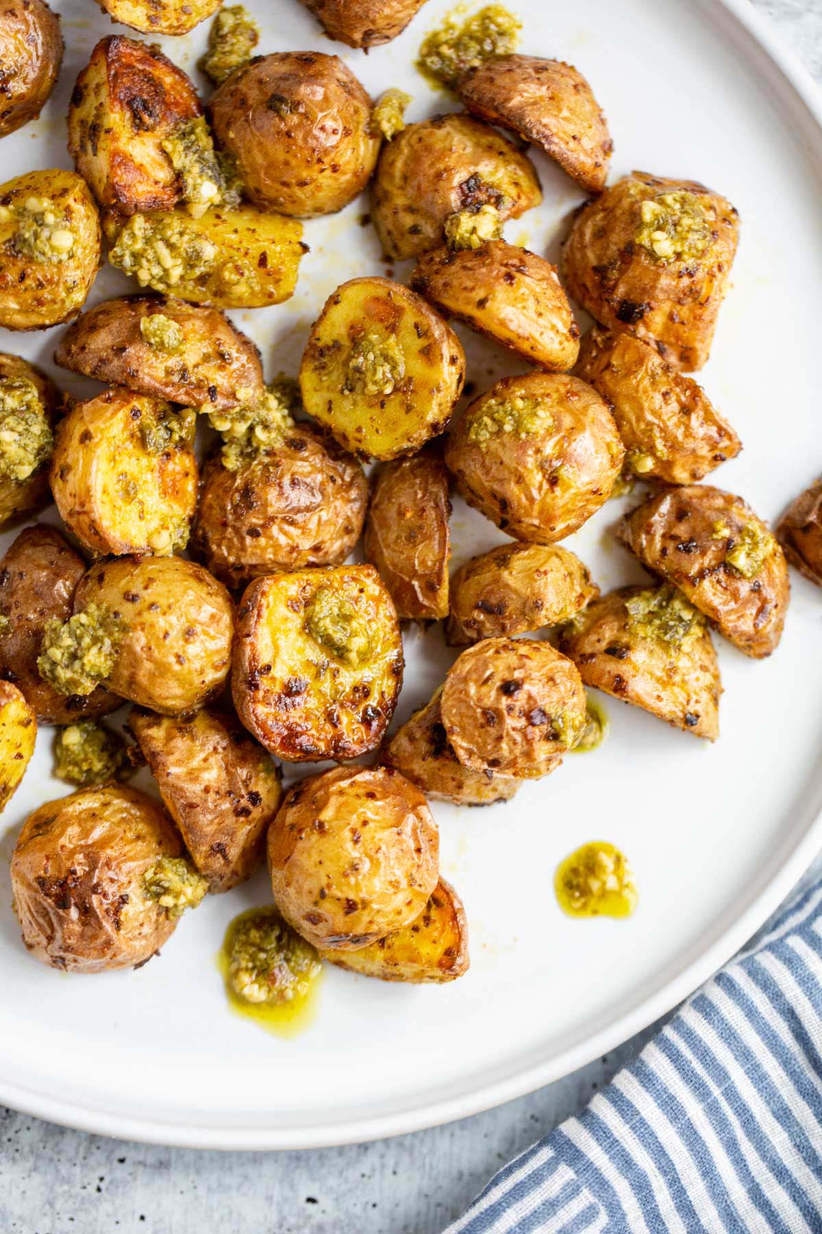 Air fryer pesto potatoes on a white plate.