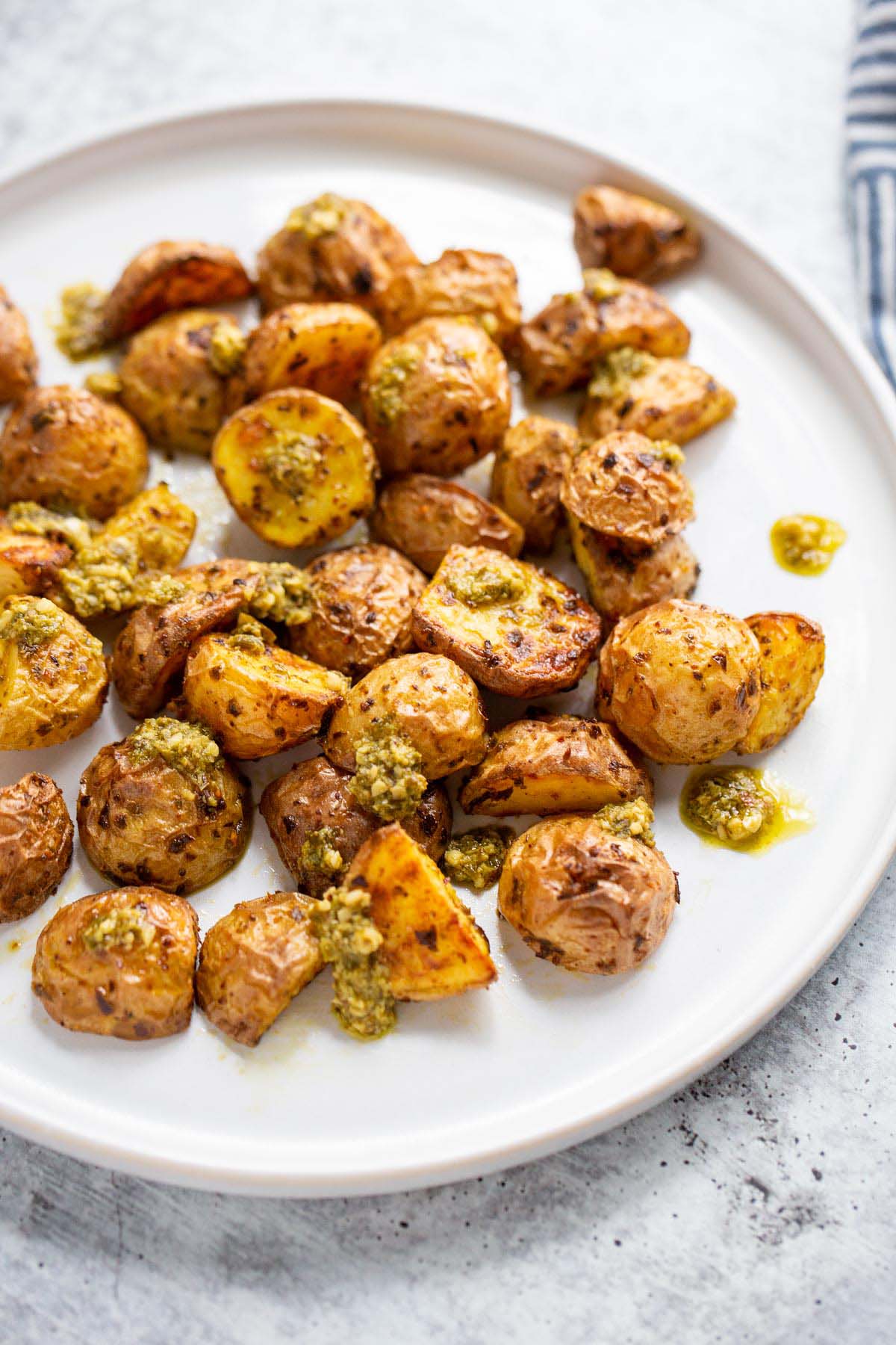 Air fryer pesto potatoes on a white plate.