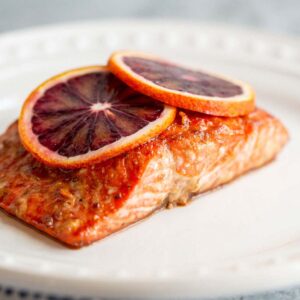 Blood orange salmon with blood orange slices on top.