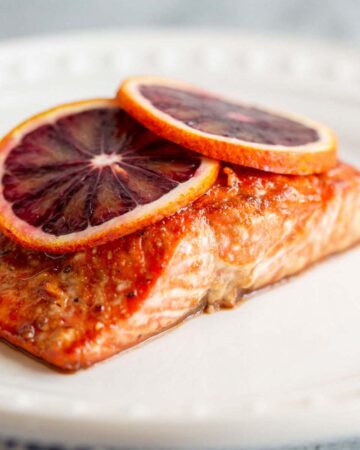 Blood orange salmon with blood orange slices on top.