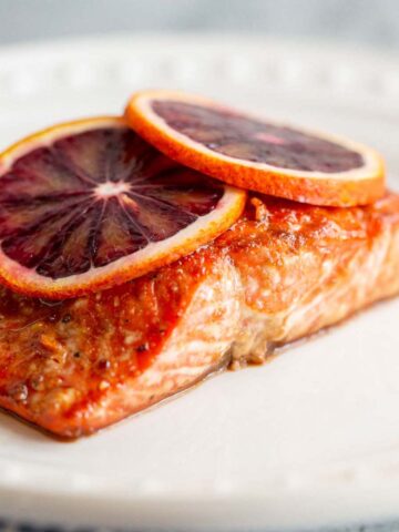 Blood orange salmon with blood orange slices on top.