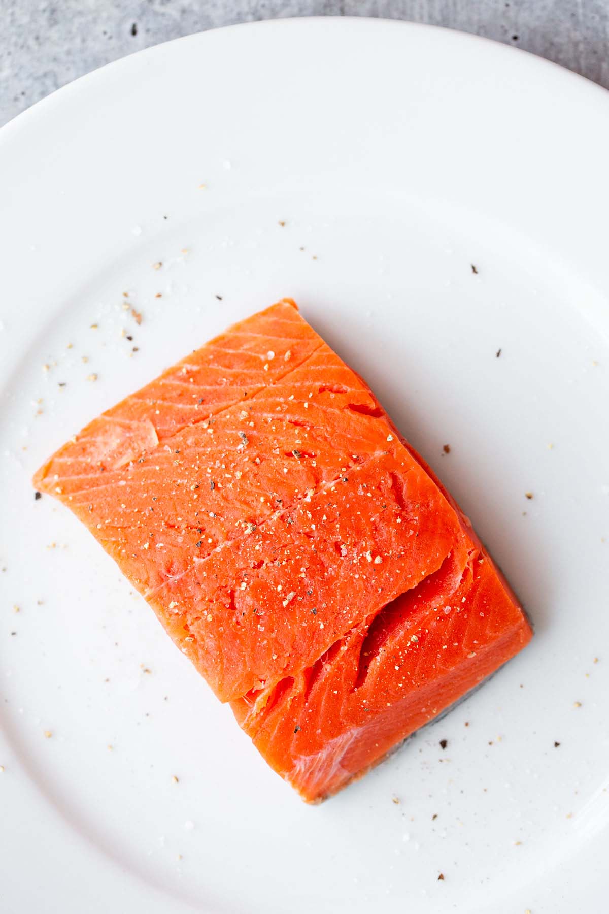 Uncooked salmon on a plate.