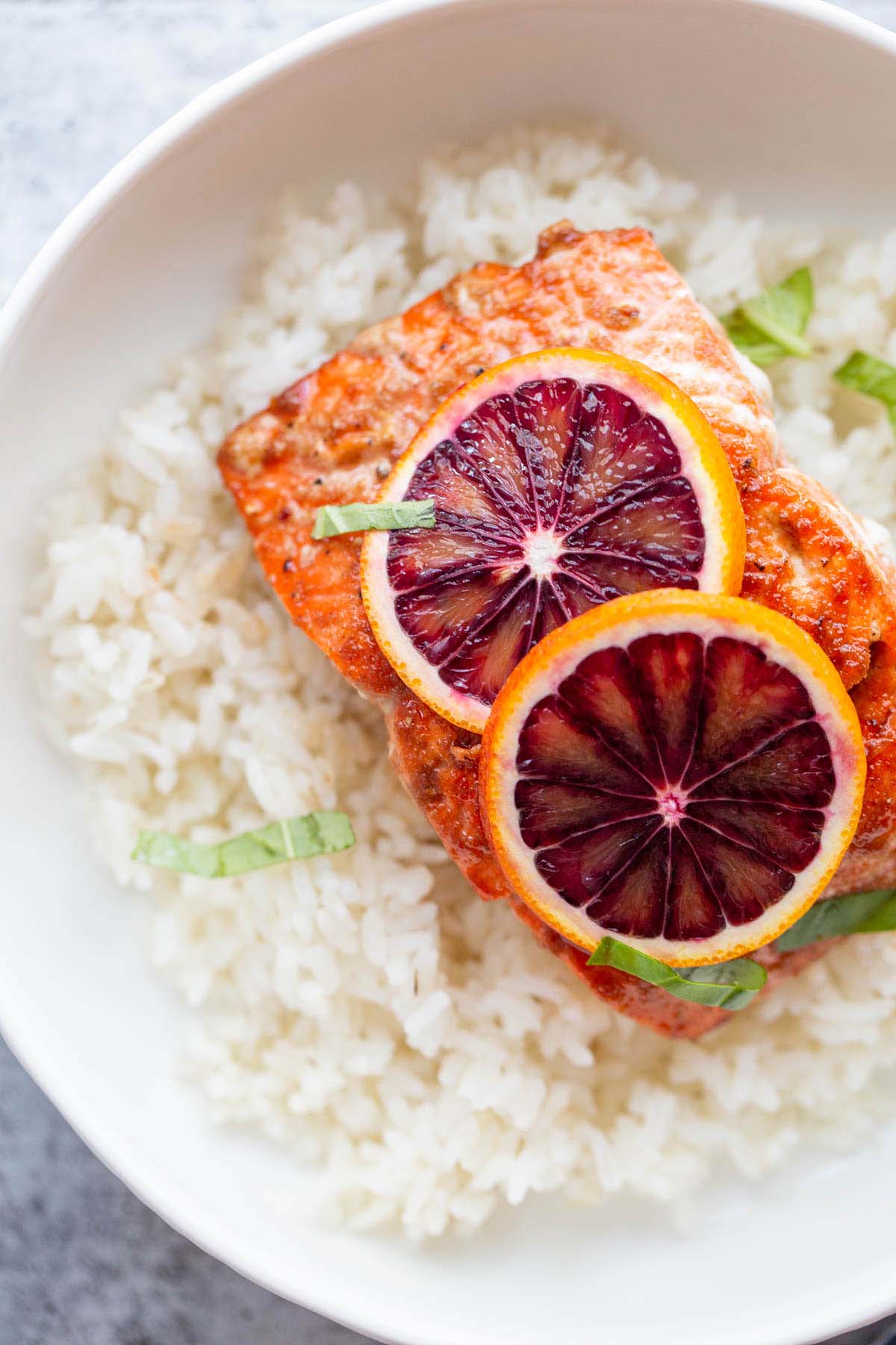 Salmon with rice and blood orange slices.