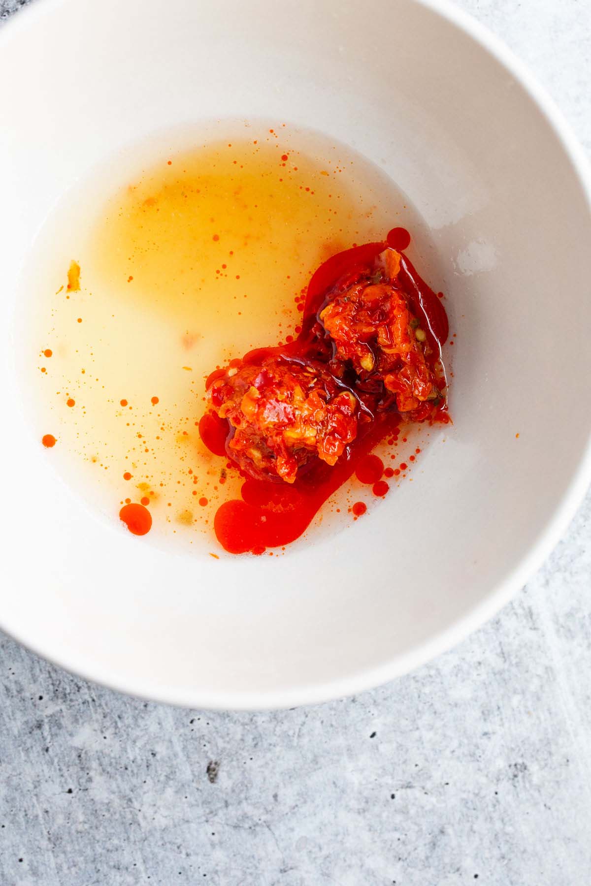 Lemon juice and calabrian chile paste in a bowl.