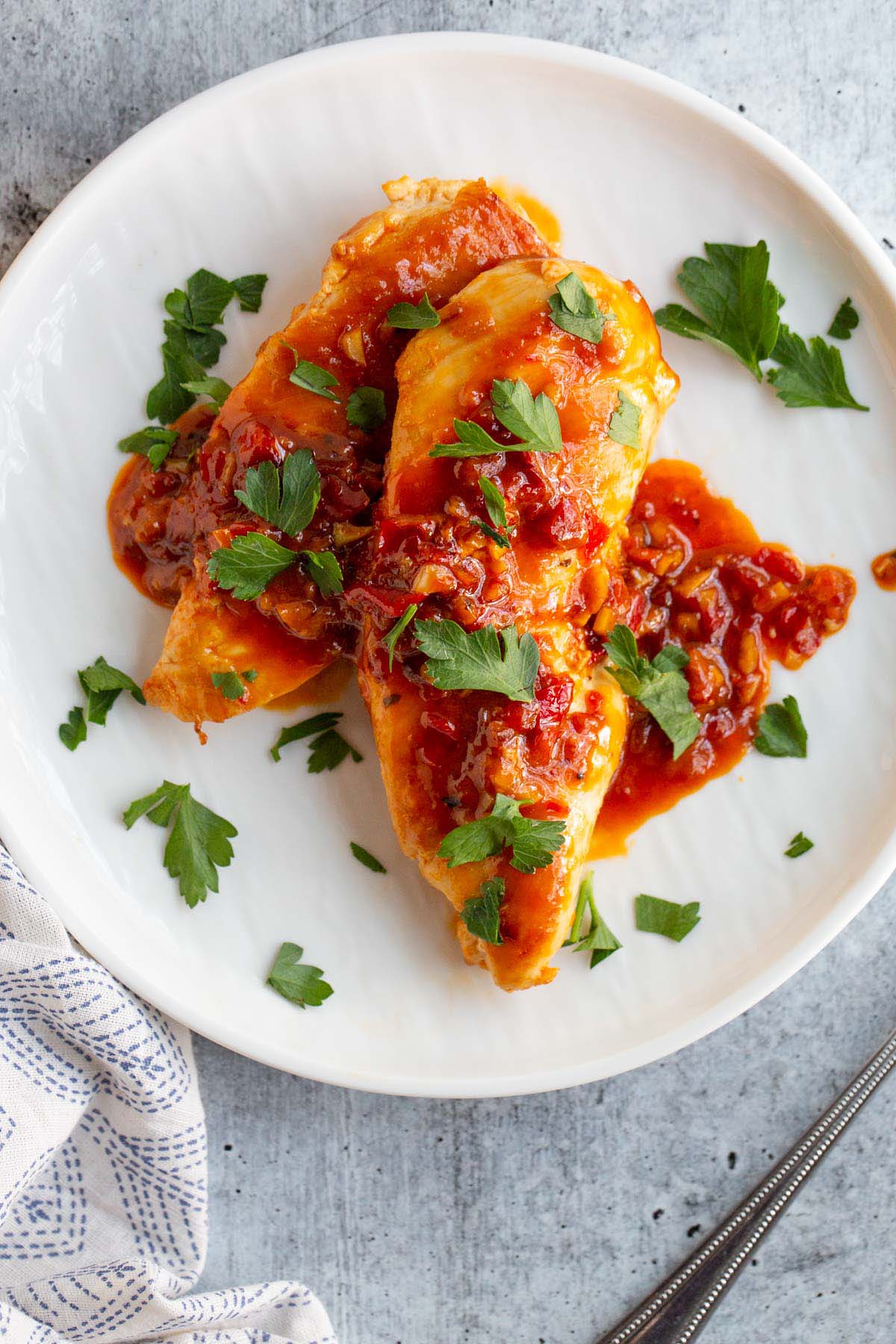 Calabrian chicken topped with fresh parsley.