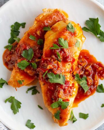 Calabrian chicken on a plate with parsley.