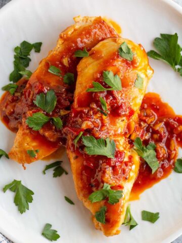Calabrian chicken on a plate with parsley.