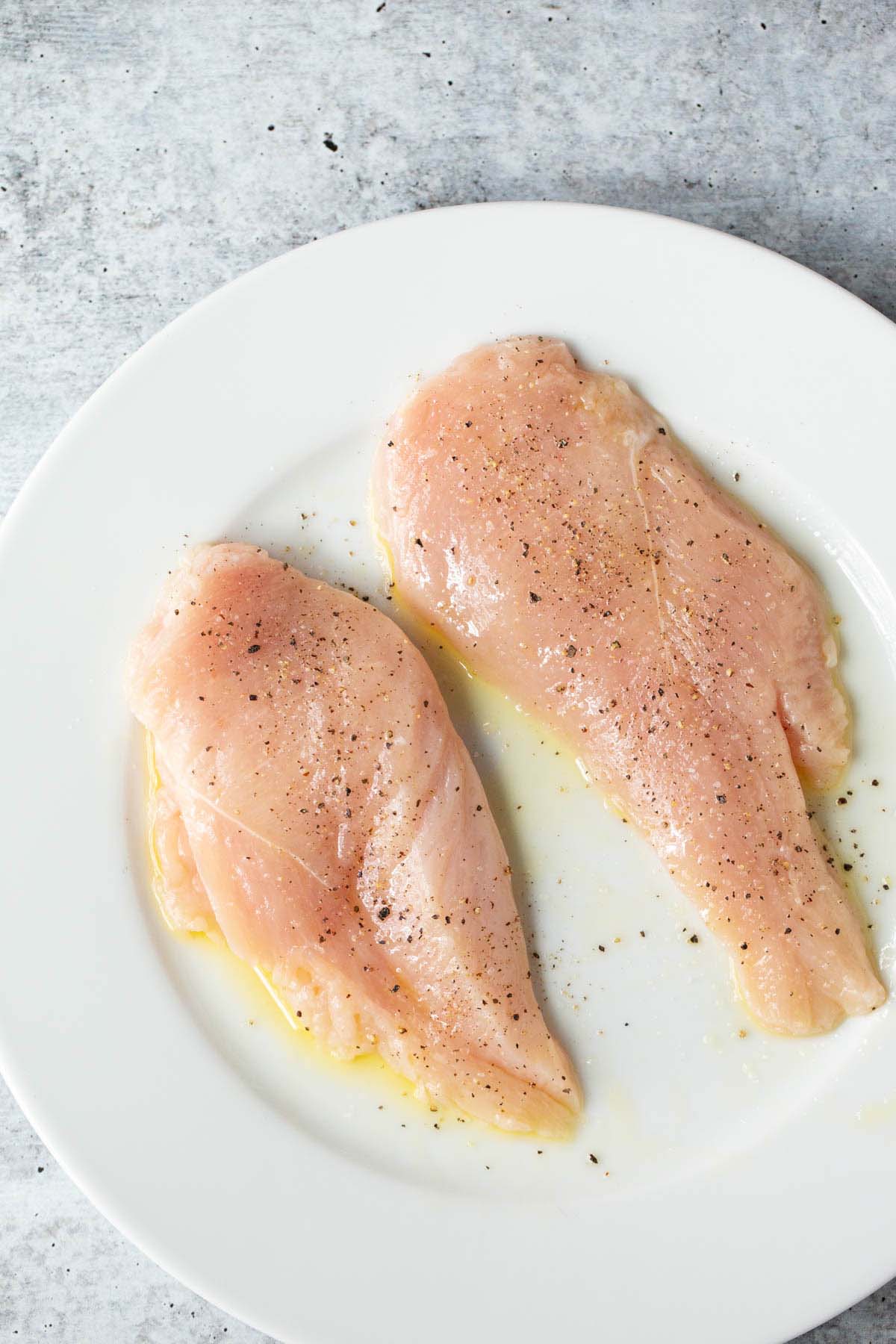 Raw chicken on a plate.