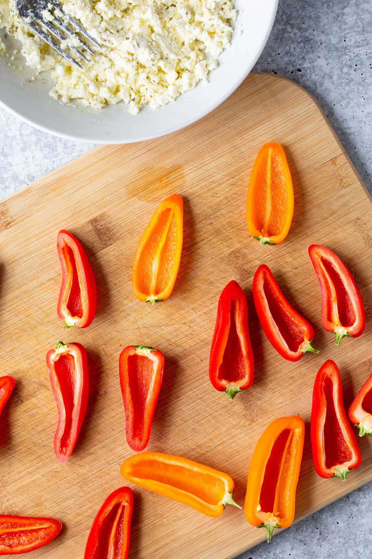 Stuffing mini peppers.