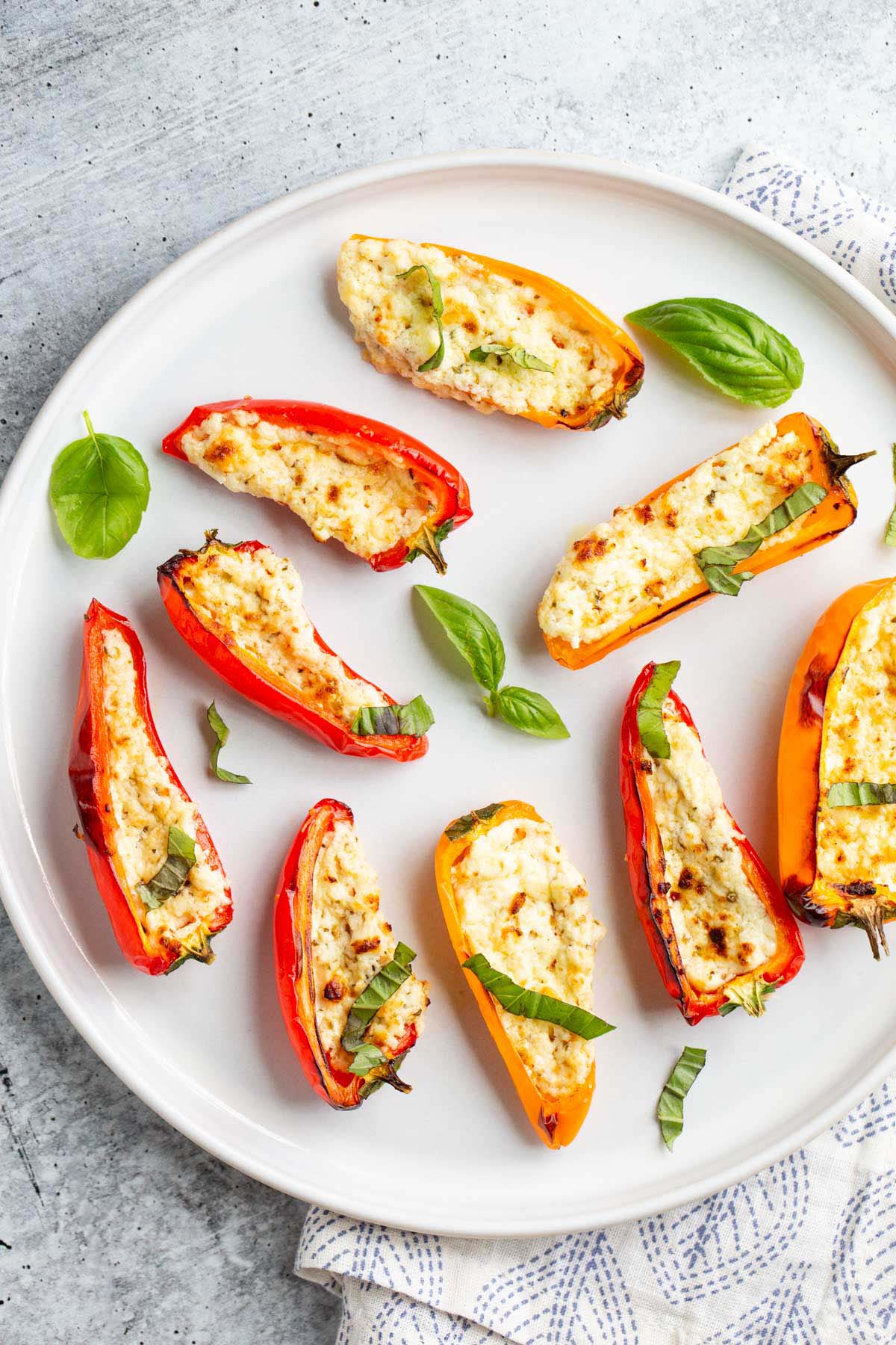 Feta stuffed mini peppers on a plate.