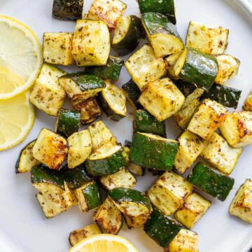 Roasted zucchini with lemon slices.