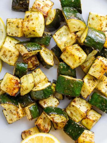 Roasted zucchini with lemon slices.