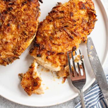 Air fryer crispy onion chicken cut into with a fork and knife.