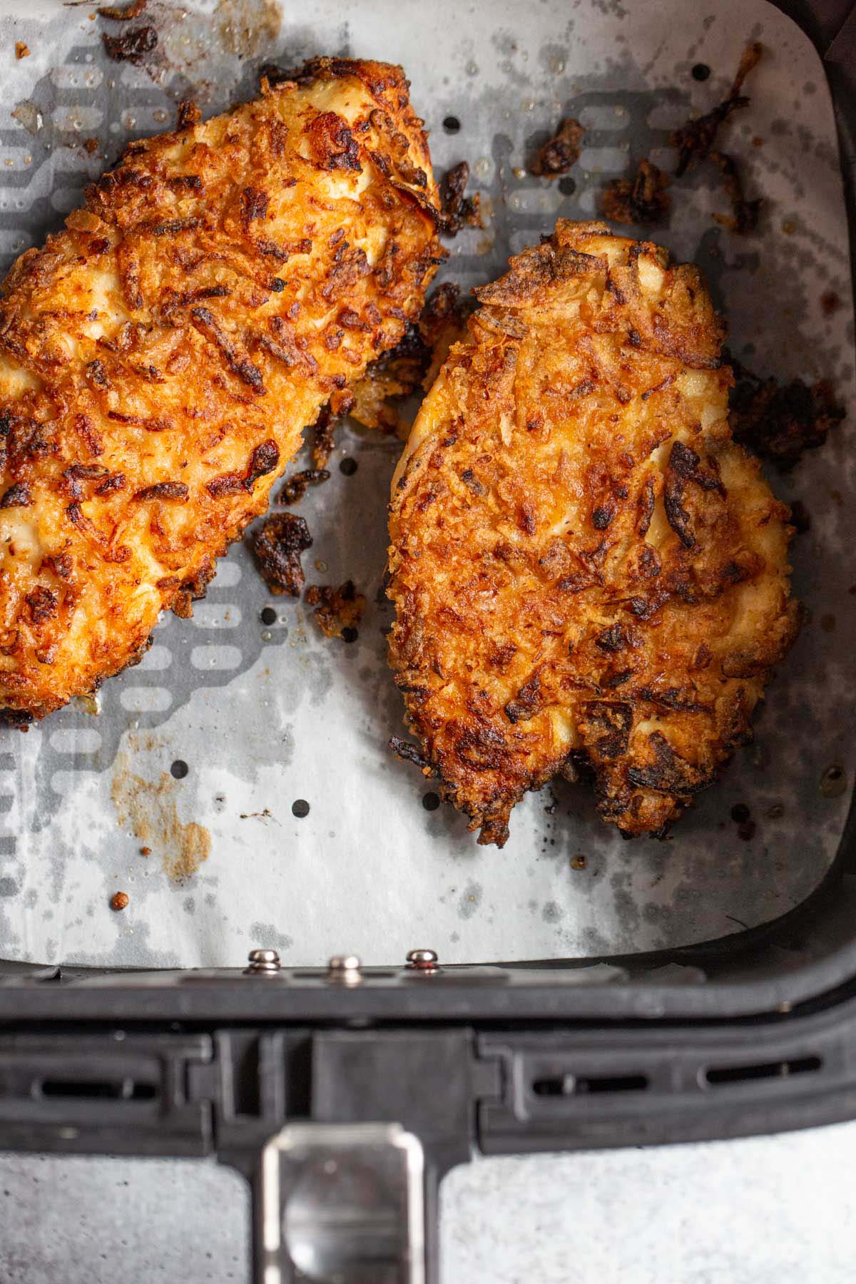 Air fryer crunchy onion chicken in air fryer basket.