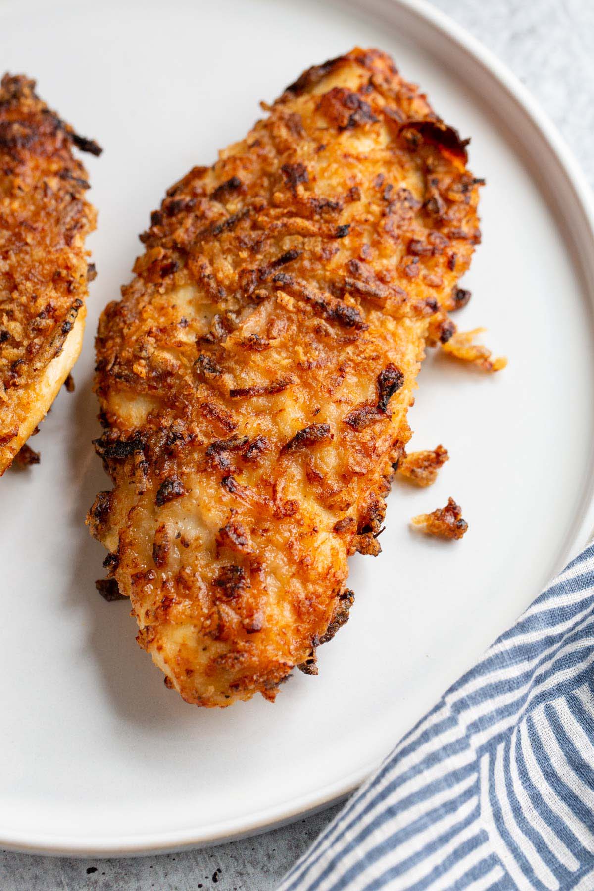 French onion crunch chicken on a white plate up close.