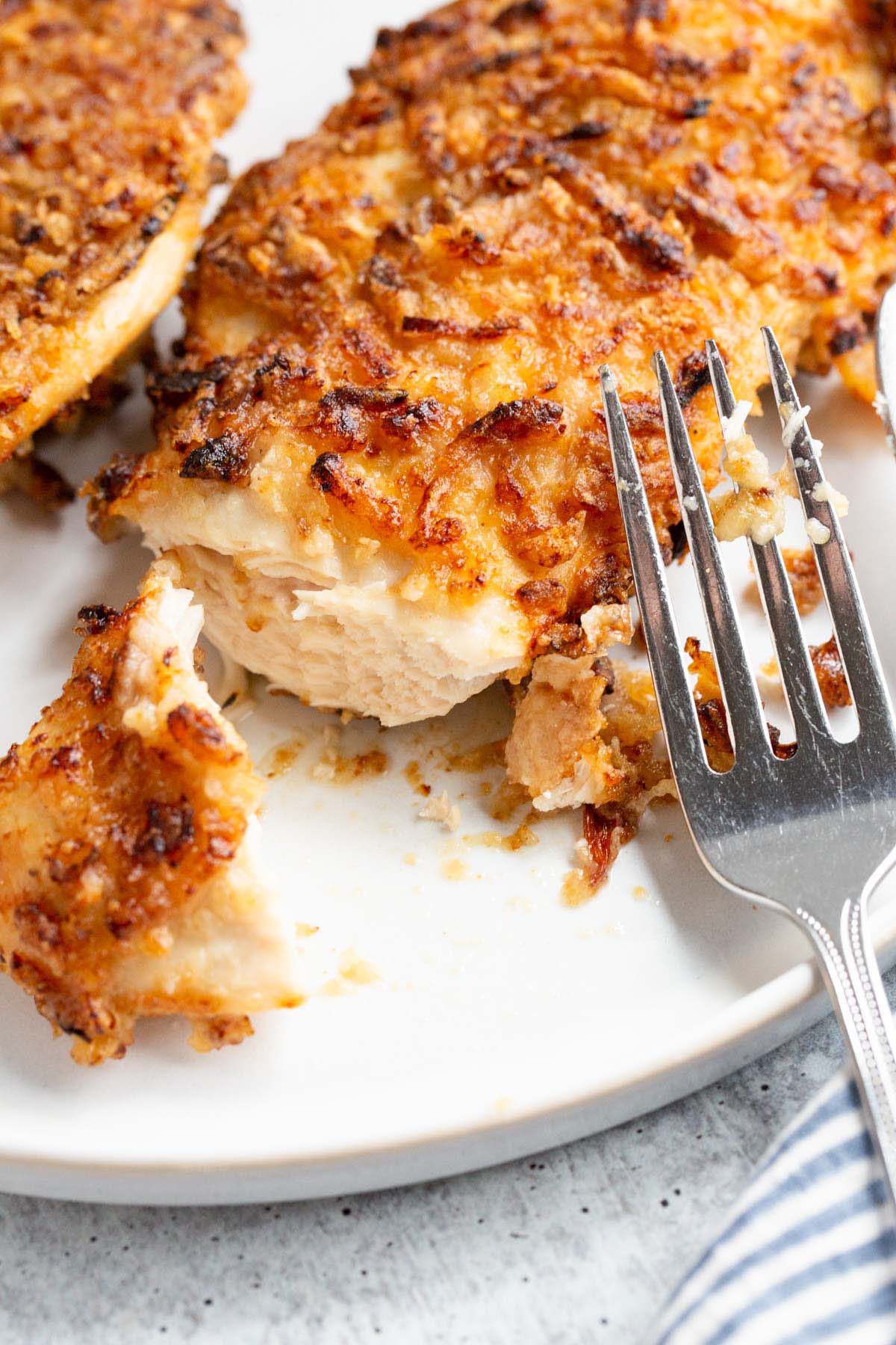 French onion crunch chicken on a white plate up close.