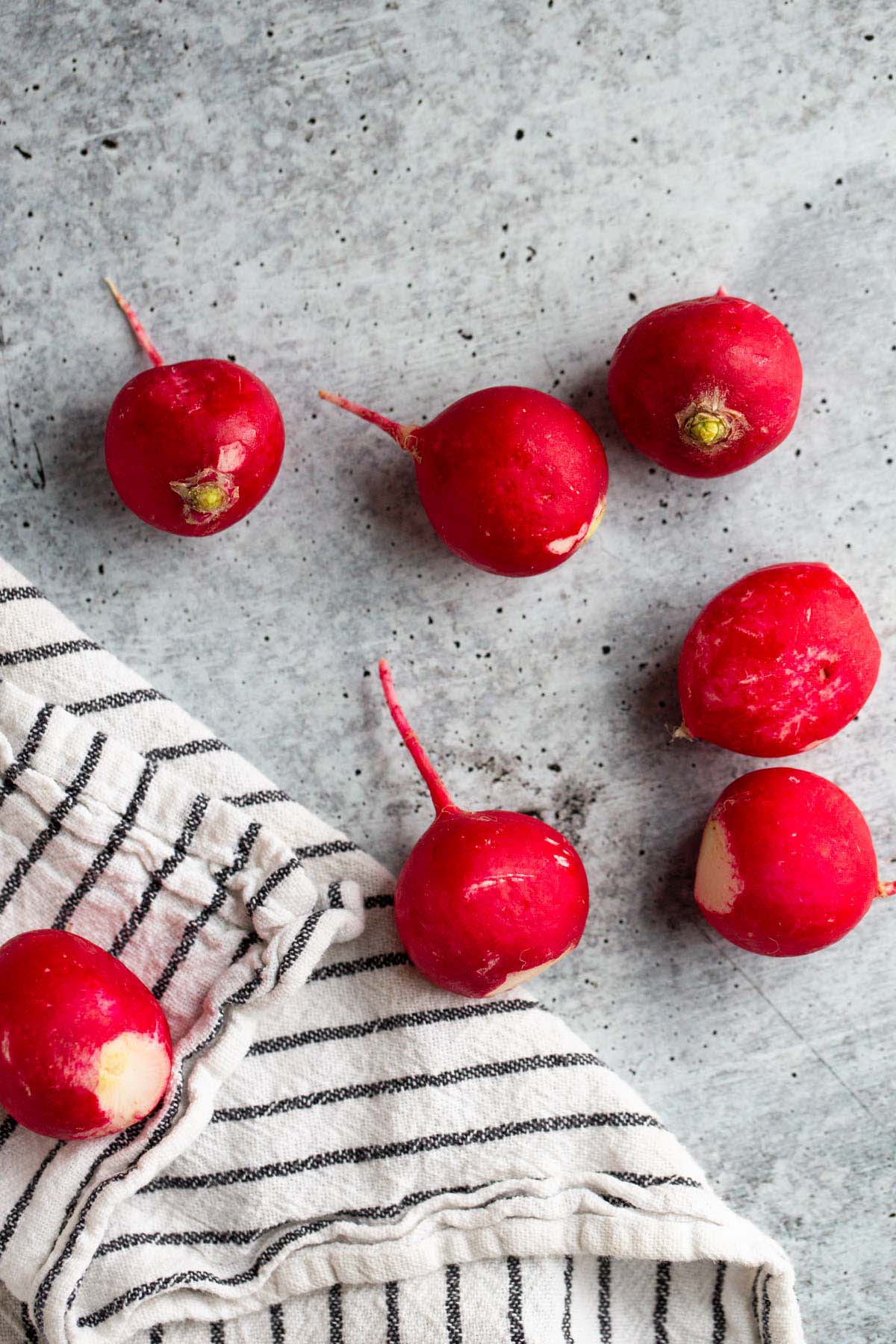 Raw radishes with a dishtowel.