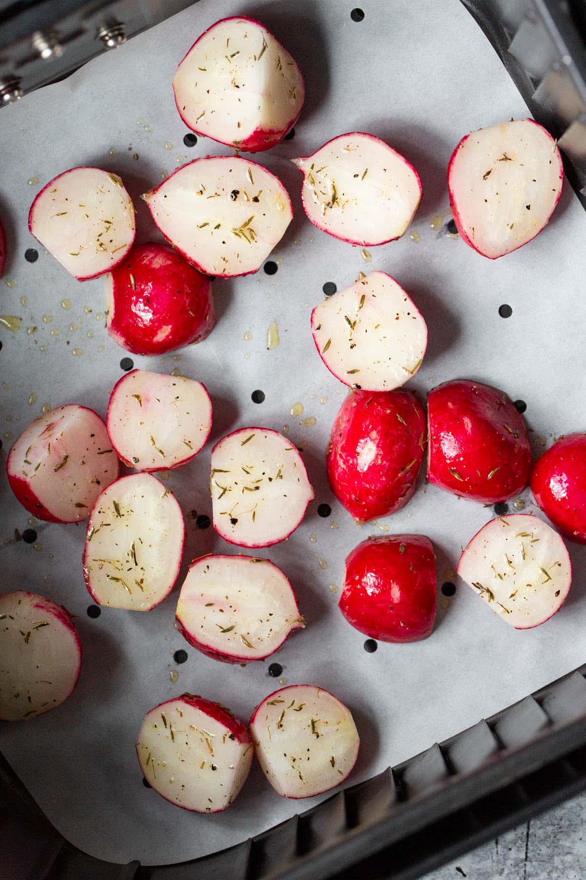 Uncooked radishes in air fryer basket.