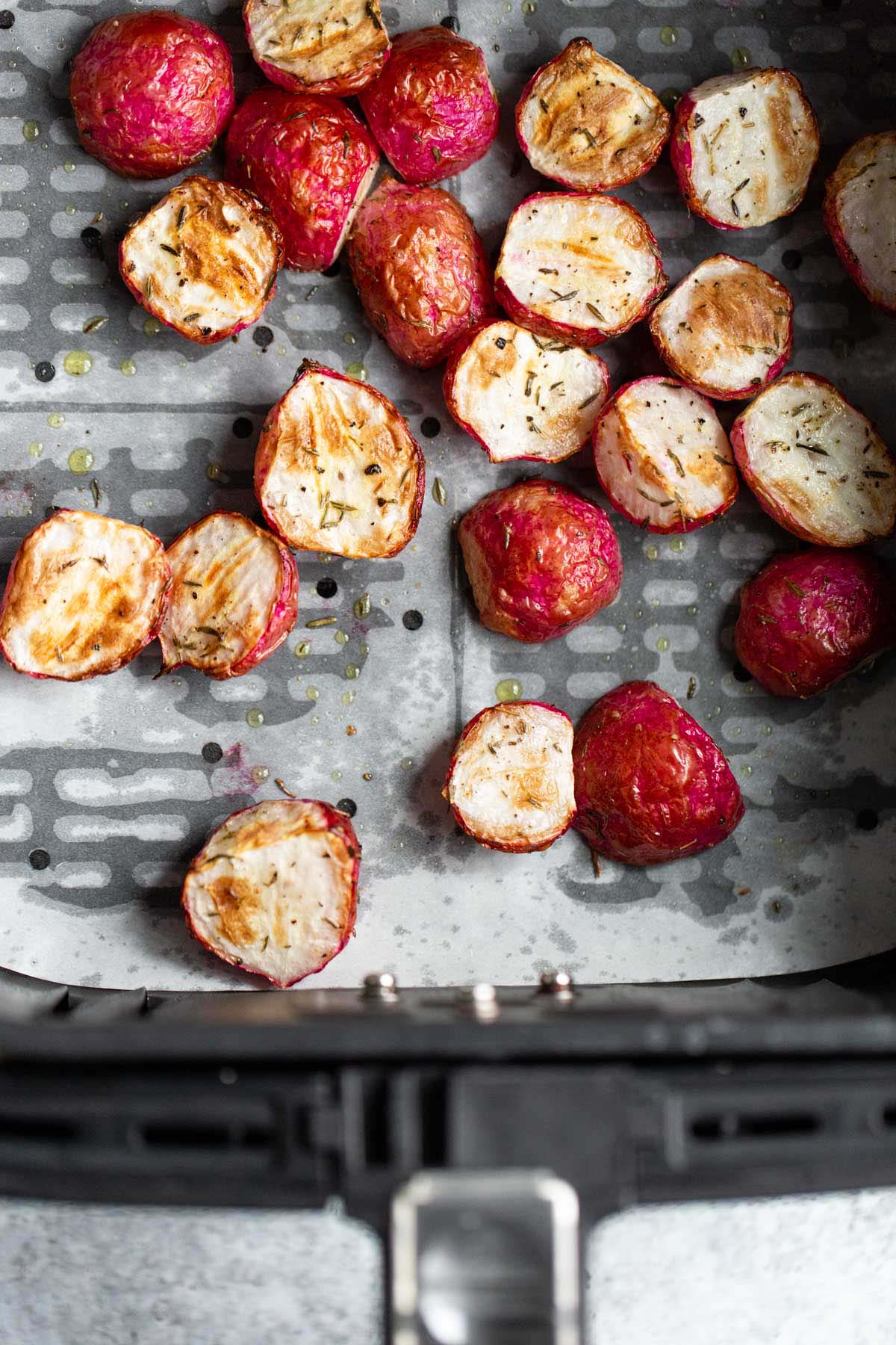 Roasted radishes in air fryer basket.