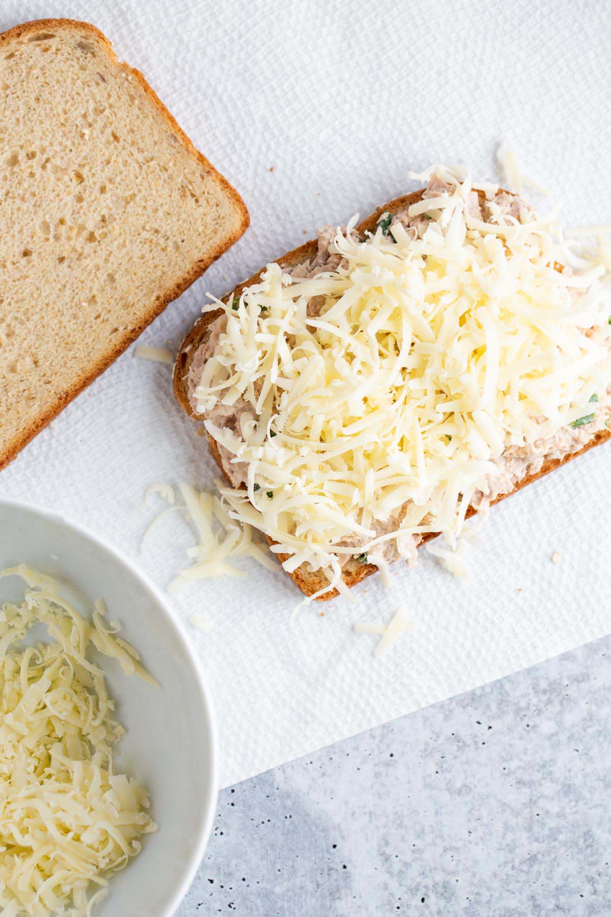 Adding cheese to a tuna melt