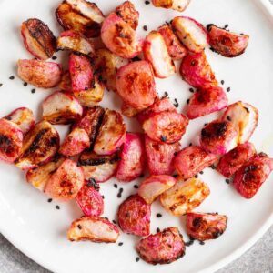 Roasted miso radishes topped with black sesame seeds.