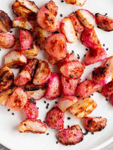 Roasted miso radishes topped with black sesame seeds.