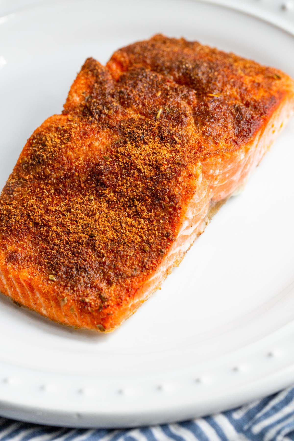 Air fryer blackened salmon on a plate.