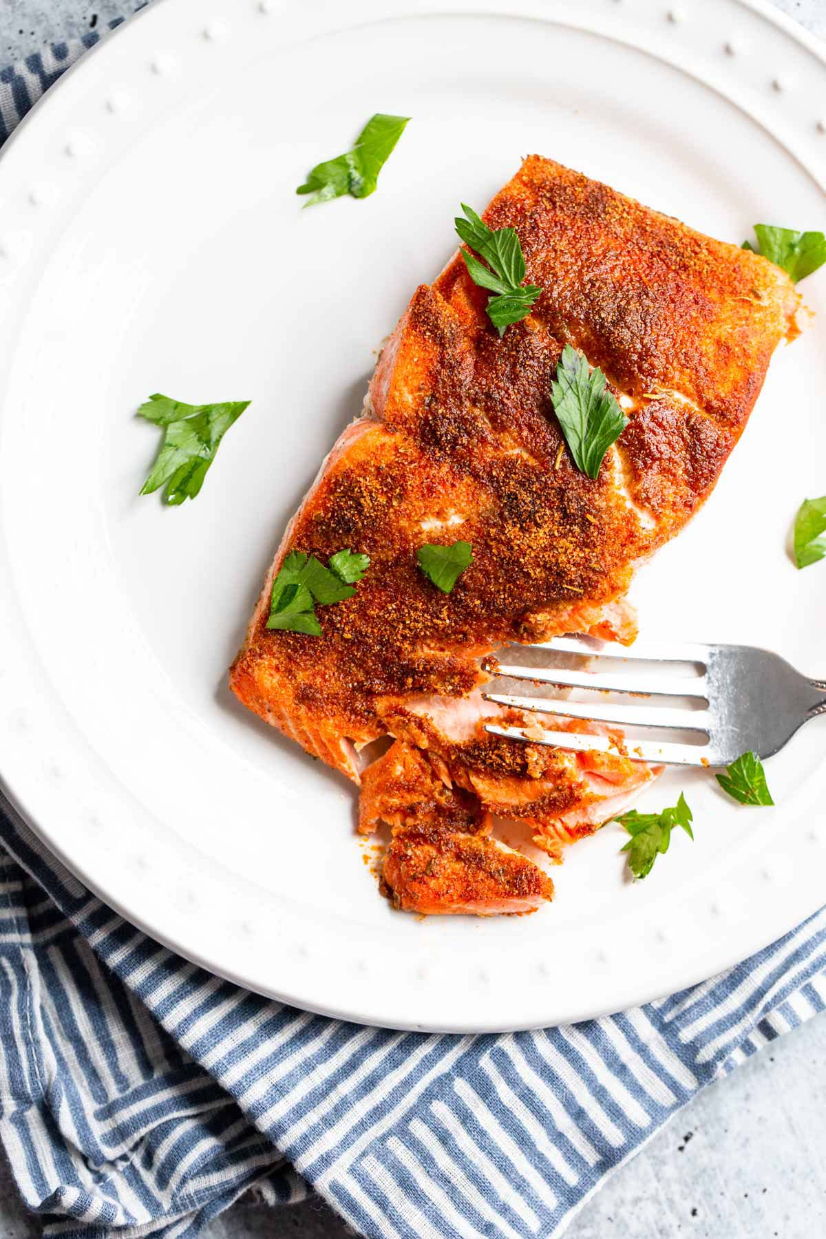 Air fryer blackened salmon on a plate.