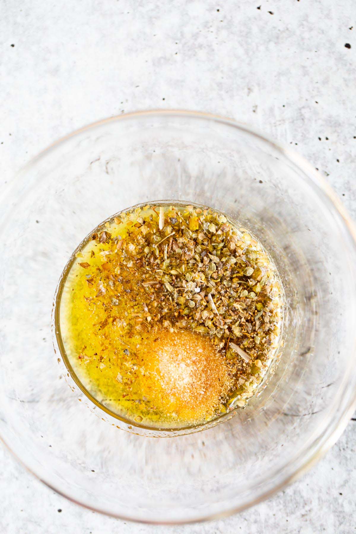 Herbs and olive oil in a bowl.