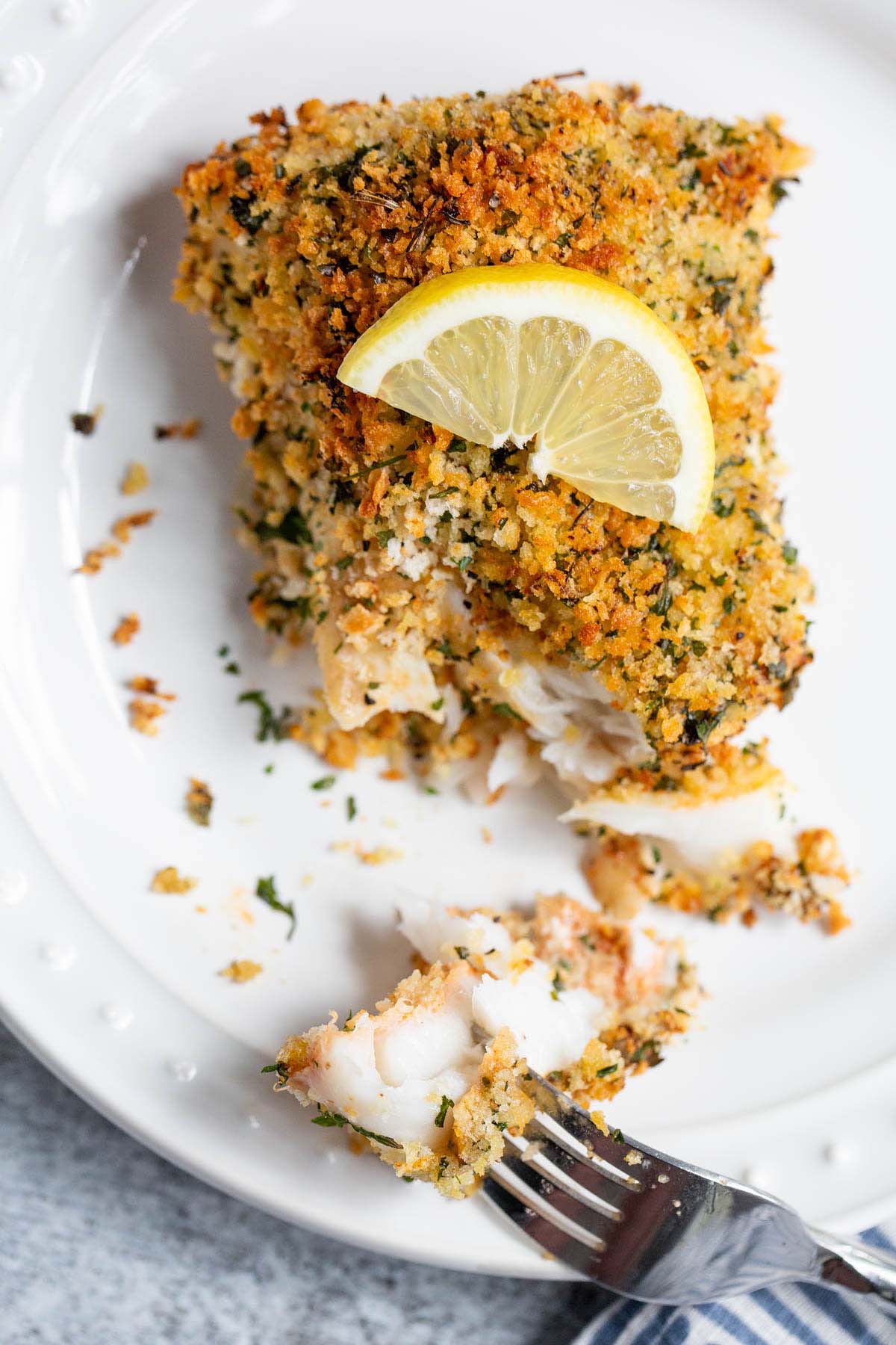 Air fried panko cod with a wedge of lemon on top.