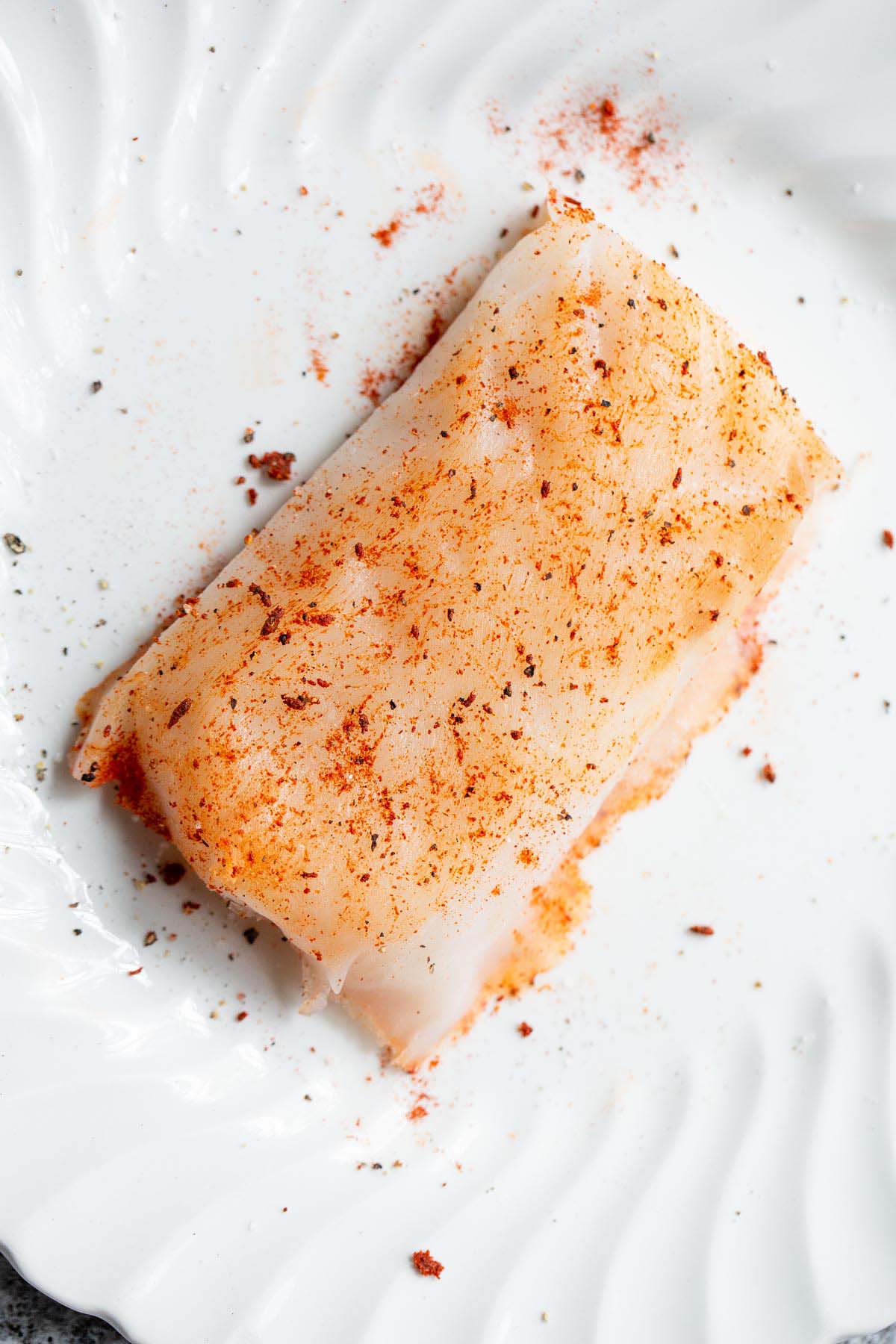 Cod seasoned with salt, pepper, and paprika.