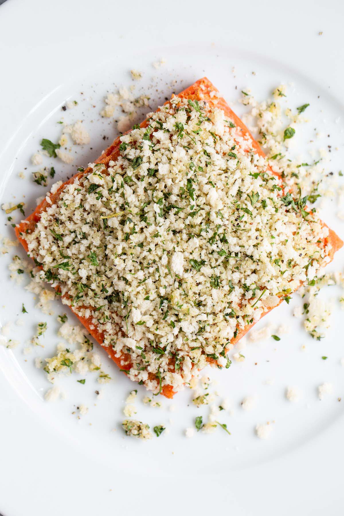 Adding panko to salmon.