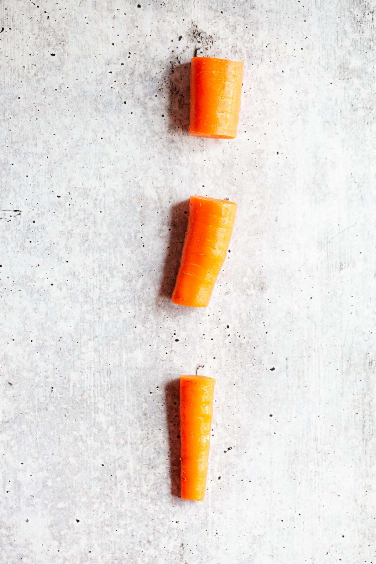 Carrot sliced into three sections.