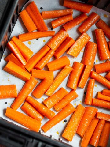 Carrots in air fryer basket.