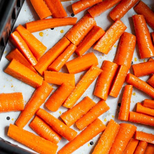 Carrots in air fryer basket.