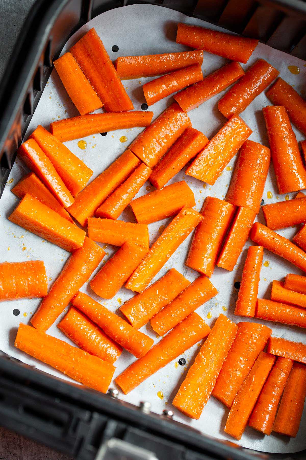 Carrots in air fryer basket.