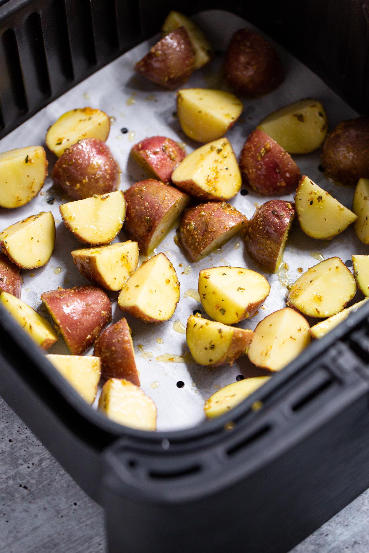 Uncooked potatoes in air fryer.