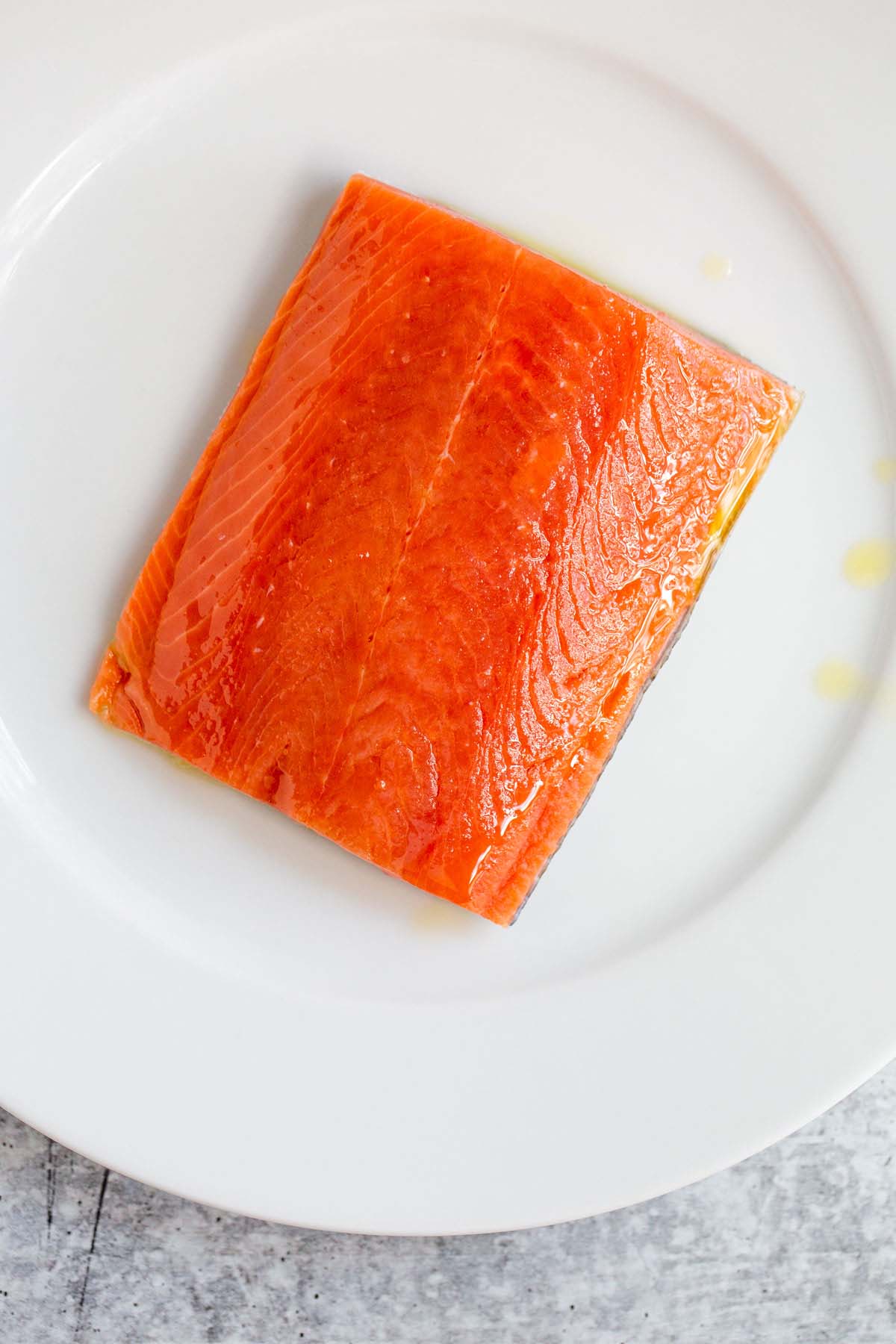 Uncooked salmon fillet with olive oil.