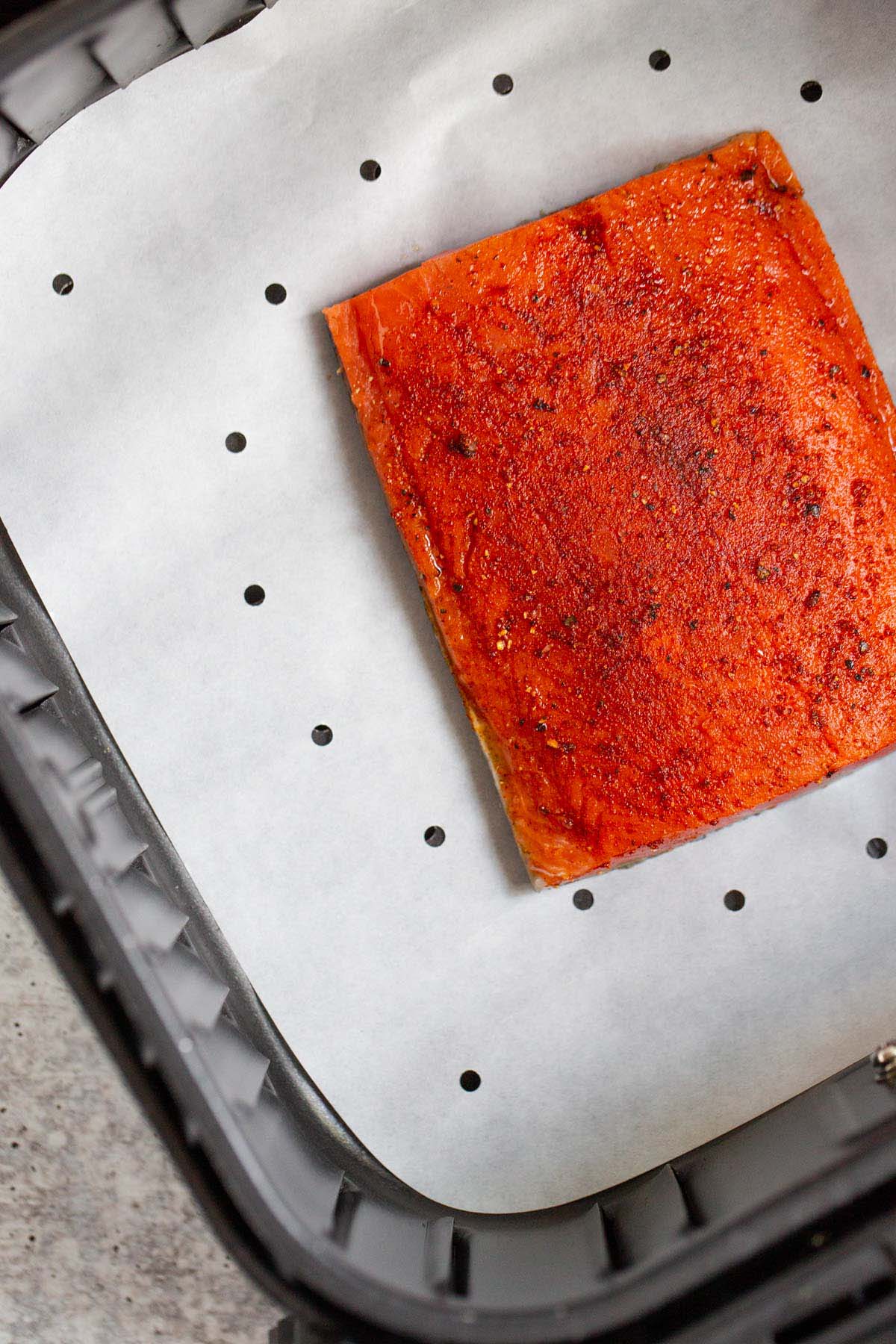 Uncooked salmon in air fryer.